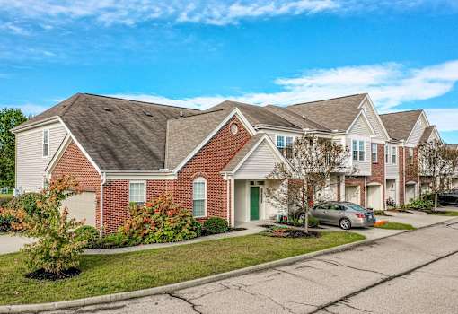 A row of houses with a car parked in front of the first one at Twin Fountains Apartments, Mason, OH, 45040