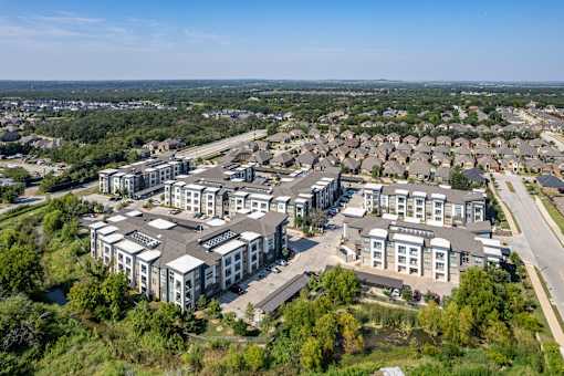A bird's eye view of a residential area with multiple houses and buildings.