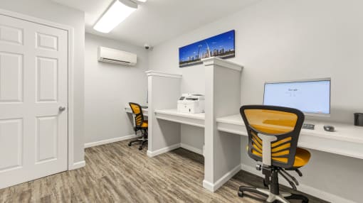an office with a computer and a desk with a chair