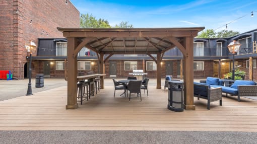 a patio with tables and chairs and a pergola