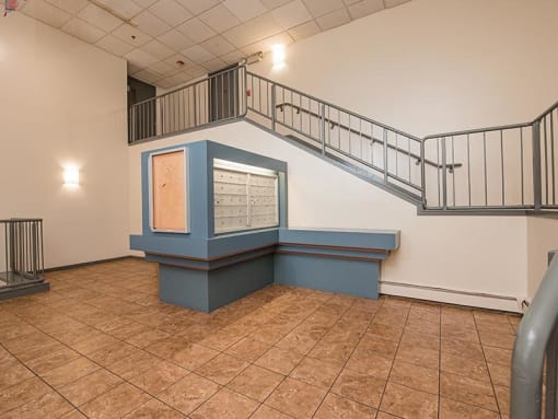 an empty room with a blue counter and stairs
