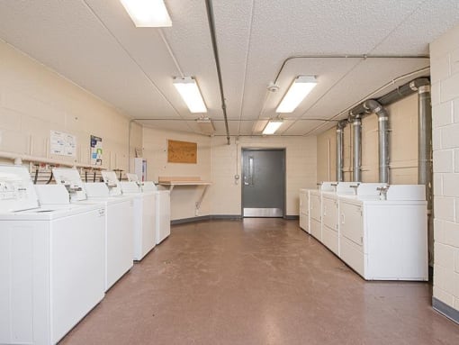 a large room with many white washing machines