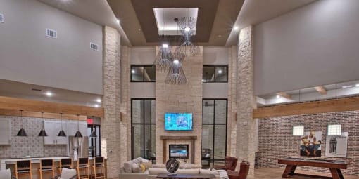 a living room with a fireplace and a television at Hunters Creek Apartments, Denton, TX