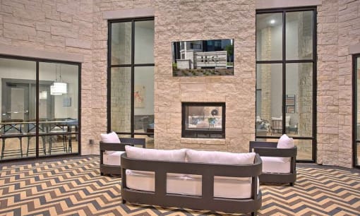 a room with a couch and a wall with a geometric design at Hunters Creek Apartments, Denton Texas