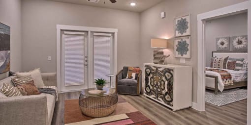 a living room with a couch and a chair at Hunters Creek Apartments, Texas, 76210