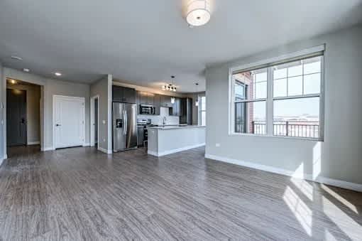 A spacious kitchen with a large island and stainless steel appliances.