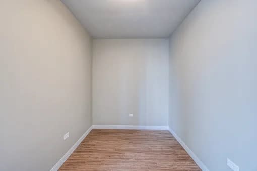 Empty room with wooden floor and white walls.