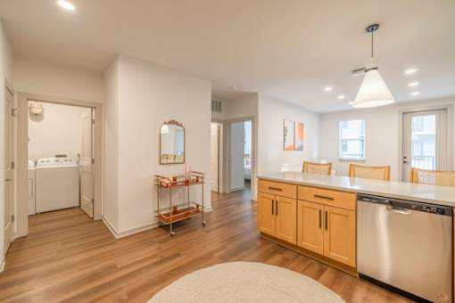 A kitchen with wooden floors and white walls.