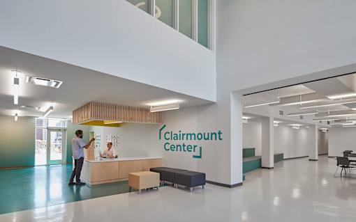 A man is standing at the Clairmount Center reception desk.