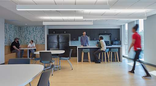 A group of people are gathered in a modern office space.