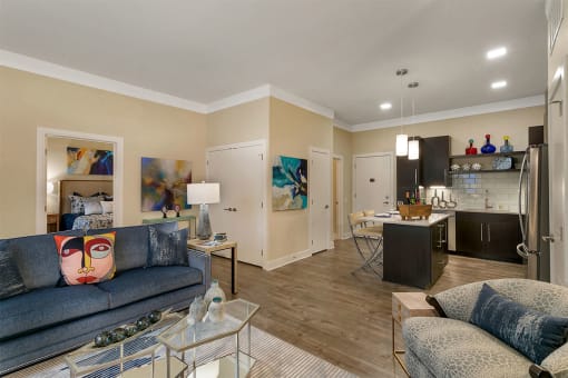 a living room and kitchen with a couch and a glass table at Aster Apartments, Ohio, 44122