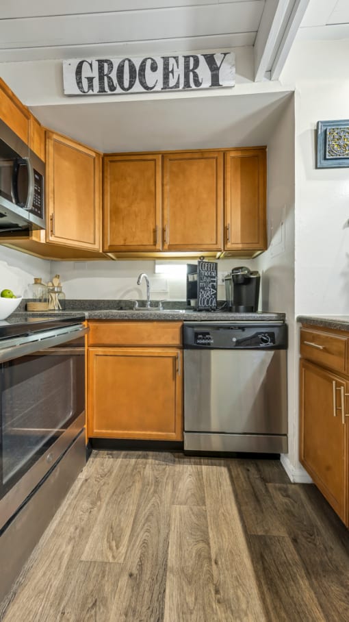 a kitchen with stainless steel appliances and wooden cabinets at Park 44, St. Louis, 63108
