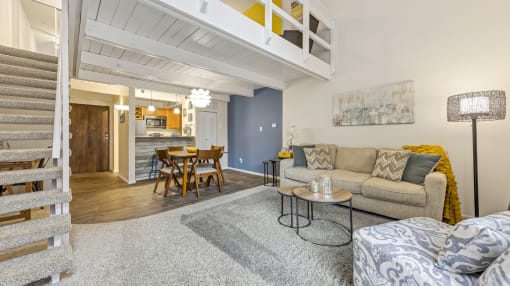 a living room with a couch and a table and a kitchen at Park 44, Missouri, 63108