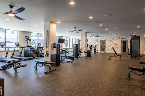 Fitness center with cardio and strength equipment at Timber Club Apartments, Missouri