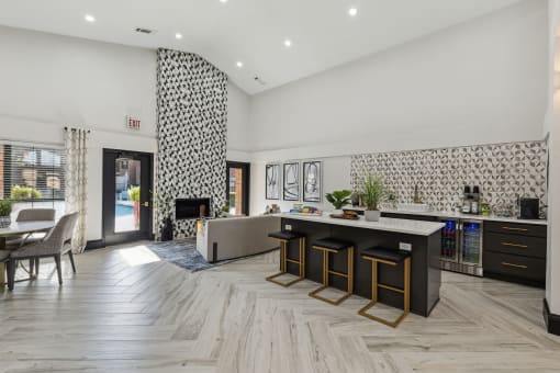 a living room with a kitchen and a fireplace at Wellington at Willow Bend Apartments, Plano, TX, 75093