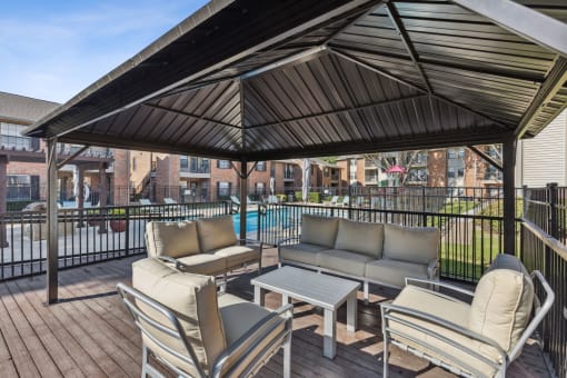 a patio with couches and chairs and a table at Wellington at Willow Bend Apartments, Plano, Texas