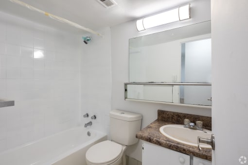 a bathroom with a sink toilet and a bath tub