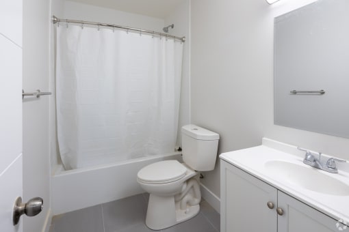 a bathroom with a toilet and a tub and a sink