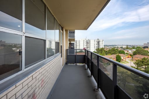 a view of the city from the balcony of an apartment