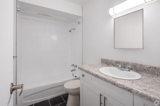 a bathroom with a sink and a shower and a toilet