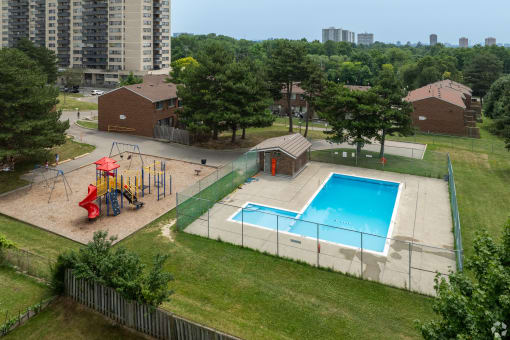 an aerial view of a playground next to a swimming pool