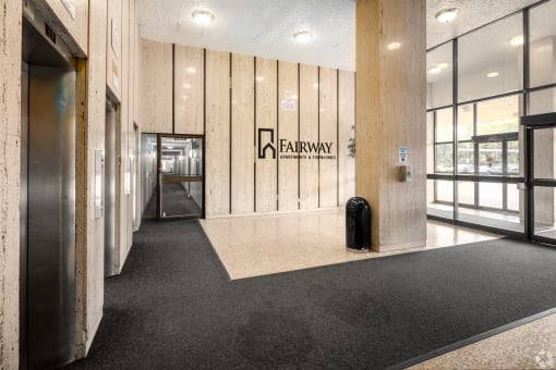 a hallway with a suitcase and a logo on the side of a building