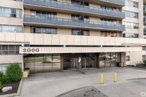 the facade of a large apartment building with glass doors