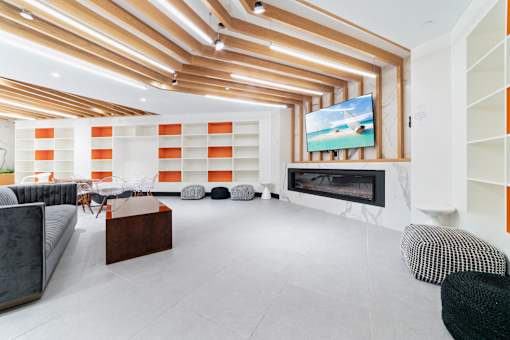 A modern living room with a fireplace and a television.
