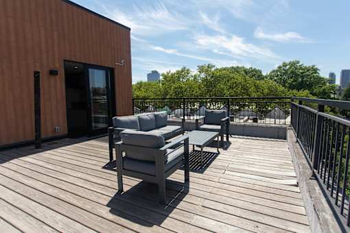 A wooden deck with two chairs and a table.