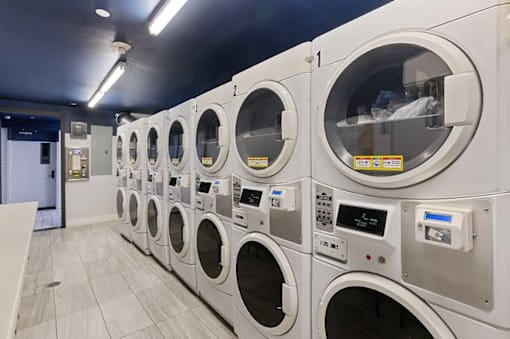 A row of washing machines in a public laundromat.