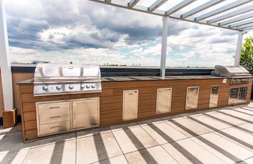 A stainless steel oven is on a wooden counter.