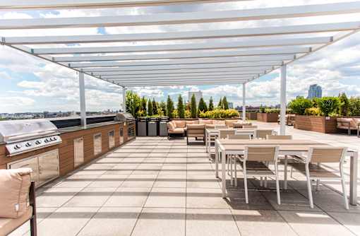 A patio with a table and chairs under a white canopy.