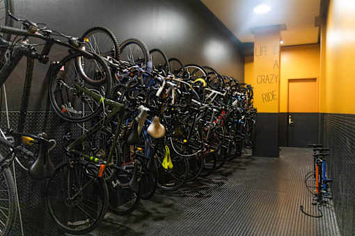 A room full of bicycles with a sign that says "Life is a crazy ride".