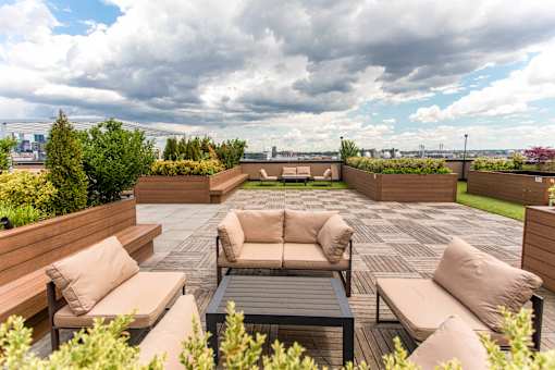 A patio with a table and chairs overlooking a city.