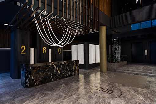 Reception desk with dramatic sculptural ceiling installation at 260 Gold Apartments, Brooklyn
