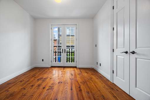 A room with wooden floors and white walls.