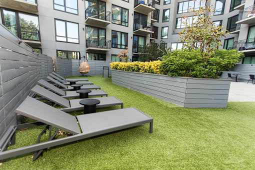 Courtyard lounge area with sundeck seating at 1134 Fulton Street Apartments, Brooklyn