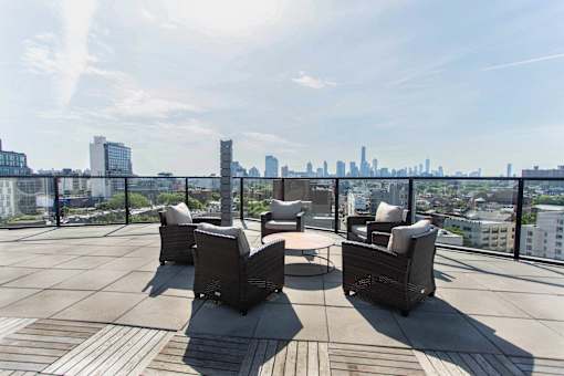 Rooftop terrace with seating and skyline views at 1134 Fulton Street Apartments, Brooklyn, 11216