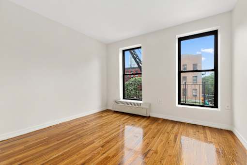 A room with a window and a radiator on the wall.