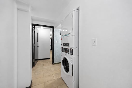A white washing machine in a laundry room.
