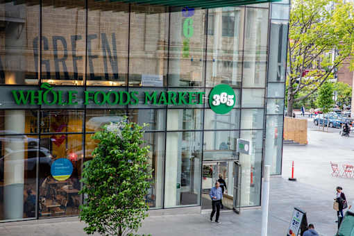 the front of a whole foods market store on a city street at The Paxton, New york