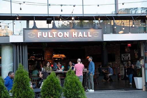people standing outside of a restaurant with a sign at The Paxton, Brooklyn, NY