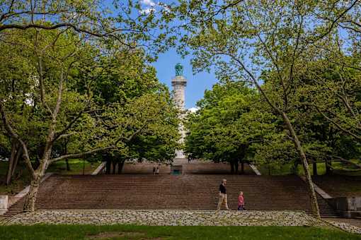 a man and two children standing on a wall in front of a lighthouse at The Paxton, Brooklyn, New York