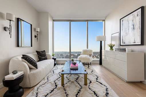 a living room with a view and a couch and a table at The Paxton, New york