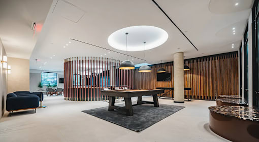 Game room with pool table and wood slat divider at 260 Gold Apartments, Brooklyn, NY 11201