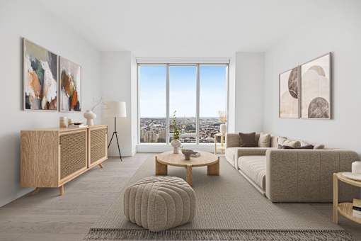 a living room with a couch and a table and a window at The Paxton, New york