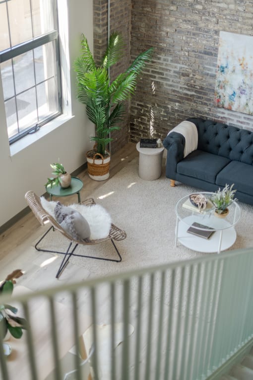 a living room filled with furniture and a large window at The 22 Apartments, St. Louis Missouri