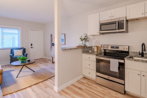 a kitchen with stainless steel appliances and white cabinets