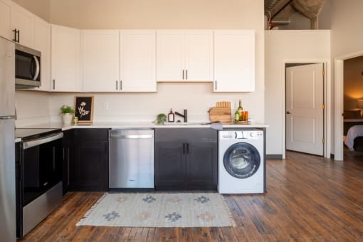 a small laundry room with a washer and dryer at The Draper, St Louis, Missouri