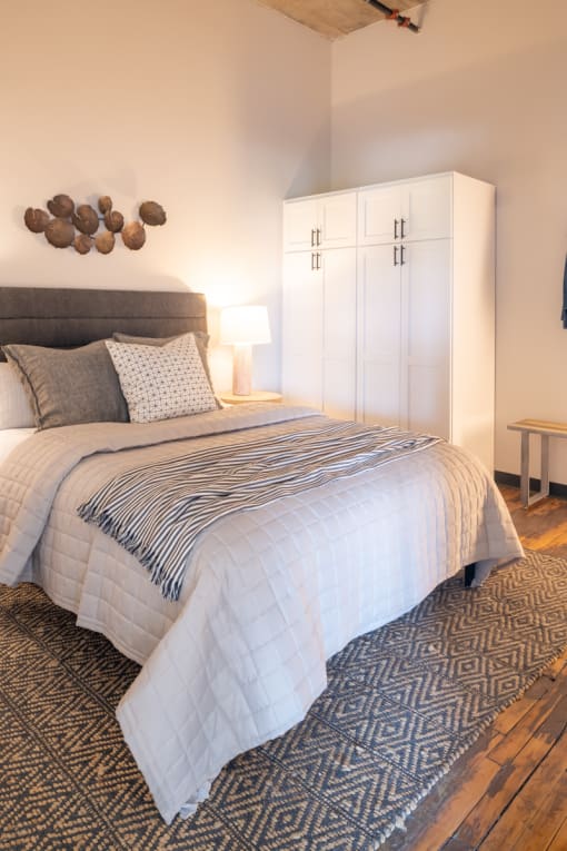 a bedroom with a large bed and a white wardrobe at The Draper, Missouri